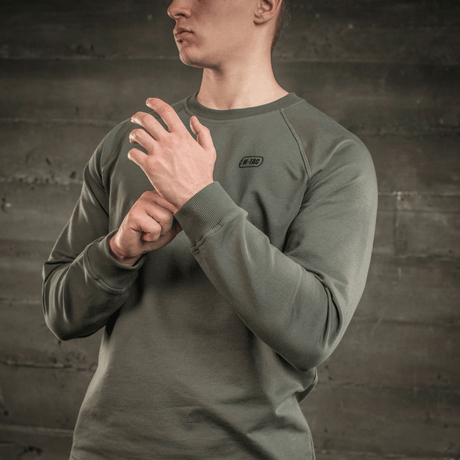 M-Tac Raglan Athlete sweatshirt with raglan sleeves in olive, designed for versatile use and maximum freedom of movement, seen on a person.