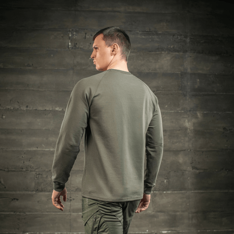Man wearing M-Tac Raglan Athlete sweatshirt in olive green, seen from the back with raglan sleeves for free movement, perfect for sports and everyday use.