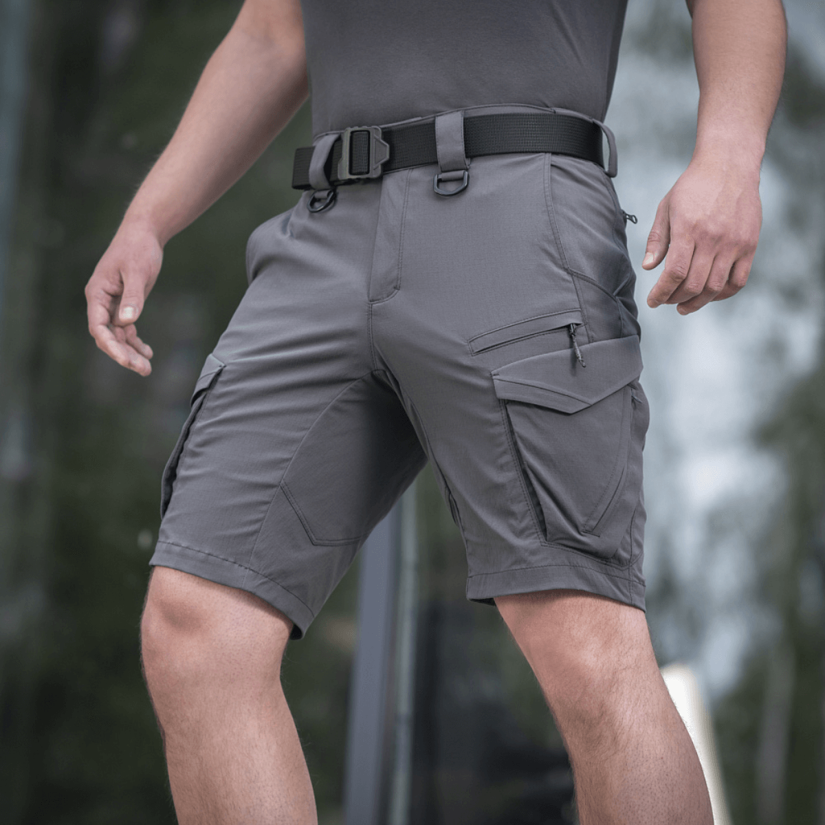 M-Tac Aggressor Summer Flex Shorts in use, showcasing tactical design with 7 functional pockets and durable Flex Rip-Stop fabric.