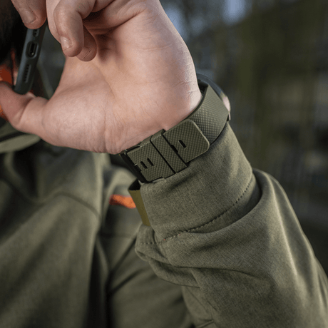 Person wearing M‑Tac Multifunctional Tactical Watch with robust case and strap, ideal for outdoor activities and military use