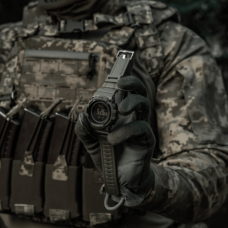M-Tac Tactical Watch with Compass 2233 held by a person in tactical clothing, showing a rugged watch design suitable for outdoor and everyday use.