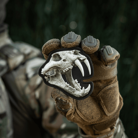 M‑Tac Patch Old Tiger with 3D tiger skull, held by a soldier in camouflage, symbolizes courage and experience, PVC with velcro fastener.