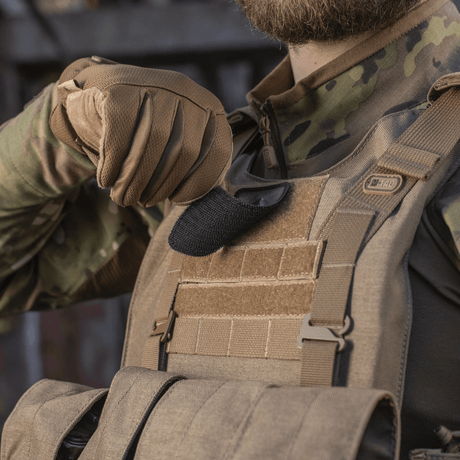 Soldier with M-Tac Spartan Helmet Patch on vest, shows bravery and strength, made from Cordura 500D for durability, 70x80 mm with Velcro.