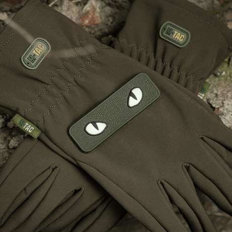 M-Tac Cat Eyes 3D PVC Patch on dark green gloves with Velcro fastening, suitable for military and outdoor use.