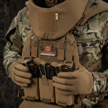 Tactical gear with M-Tac Patch Viking Evac design displayed on a camouflage uniform.
