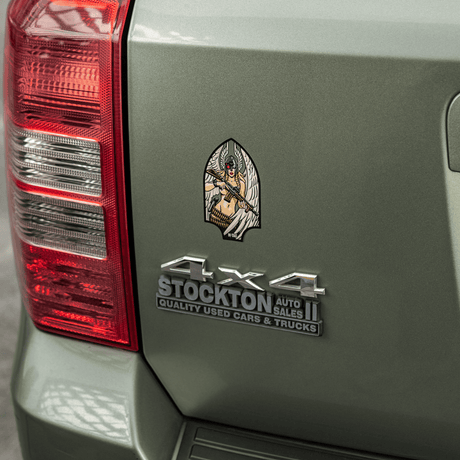 M-Tac Valkyrie sticker mounted on a car trunk, shows a mythological war goddess with M4 rifle in Arrowhead patch style.