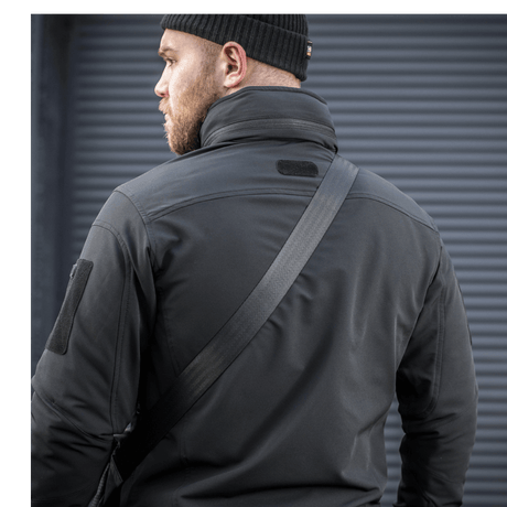 Man wearing M-Tac Konvert Bag Elite with adjustable shoulder strap in an outdoor setting.