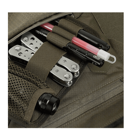 Detailed view of M-Tac Konvert Taske Elite with compartments containing a multitool and accessories, made of durable Cordura.