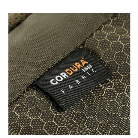 Close-up of M-Tac Konvert Taske Elite Cordura material label, showing durable fabric; the bag's brown color and pattern are visible.