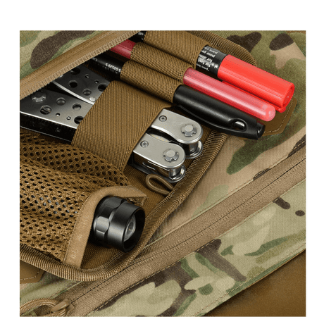 Close-up of M-Tac Konvert Taske Elite with tools in a mesh pocket.