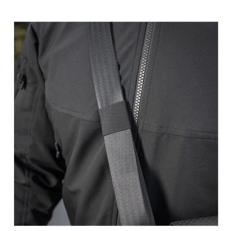 Close-up of M-Tac Konvert Taske Elite with shoulder strap on a person wearing a black jacket.
