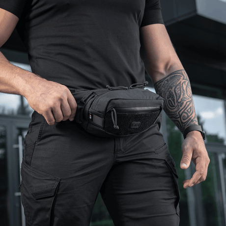 M-Tac Waist Bag Gen.II on person, compact bag with zippers and adjustable strap, made of durable 600D polyester for practical use.