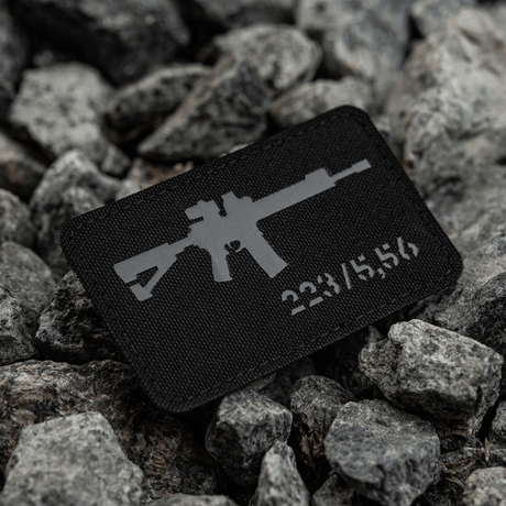 M-Tac AR-15 223/5,56 Laser Cut Patch with Velcro fastening, Cordura 500D material, designed for tactical use, placed on rocks.