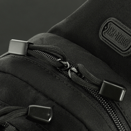 Close-up of M-Tac Assistant Bag with black zippers and MOLLE panels, perfect for daily use and customization of gear.