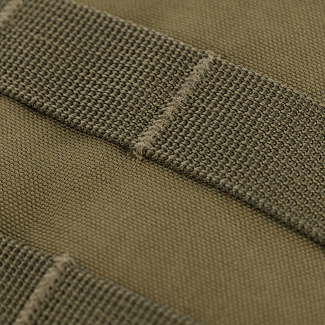 Close-up of MOLLE panel on M-Tac Assistant Bag, compact 600D backpack with adjustable strap.