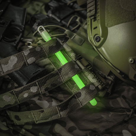 M-Tac Glow Stick 15 cm attached to camouflage gear in a dark environment.