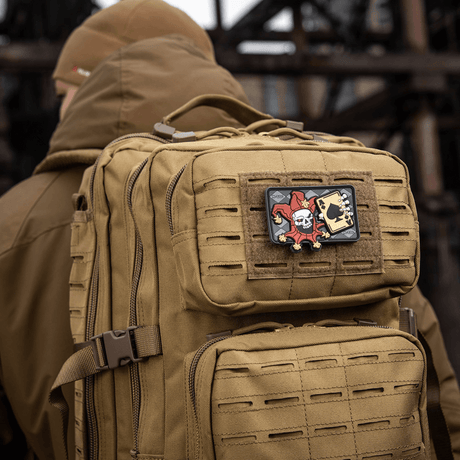 Tactical backpack with M-Tac Joker Skull 3D PVC patch with joker and death card, mounted on the backpack's front.