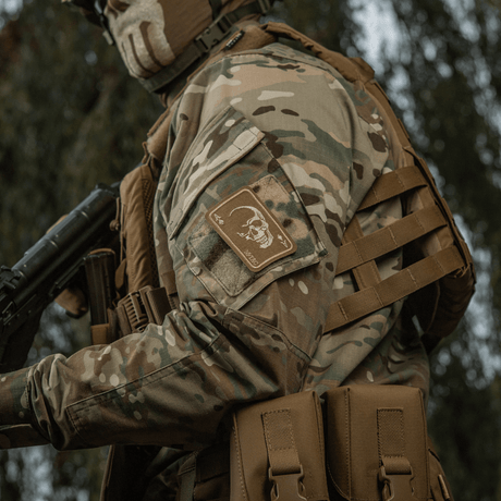 M-Tac Patch Face of War (Embroidered) on a camouflage jacket with a fearless skull motif inspired by the Vietnam War 'card of death'.