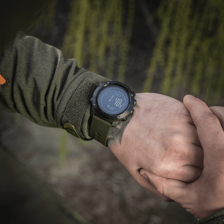 Person wearing M‑Tac Multifunctional Tactical Watch displaying digital time, ideal for outdoor and military use