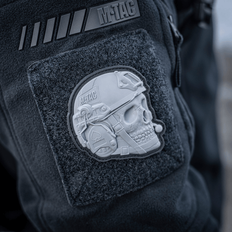 M-Tac Patch Operator 3D PVC on a jacket with realistic design, Velcro attachment, suitable as a morale patch. Size approx. 6 x 7 cm.