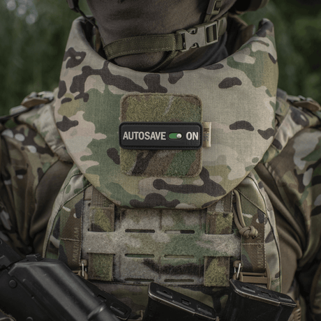 M-Tac Patch Autosave PVC in camouflage, mounted on a military vest to show focus and dedication, with Velcro backing for easy attachment.