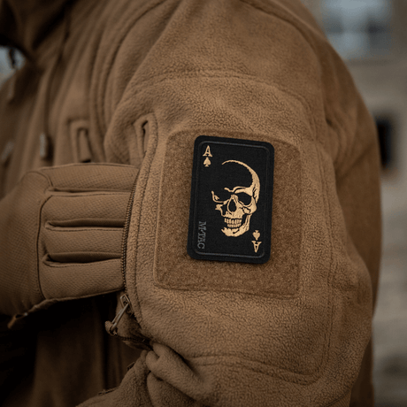 M-Tac Patch Face of War (Embroidered) on a jacket with skull-on-card symbol, inspired by the Vietnam 'card of death', Cordura 500D, Velcro-mounted.