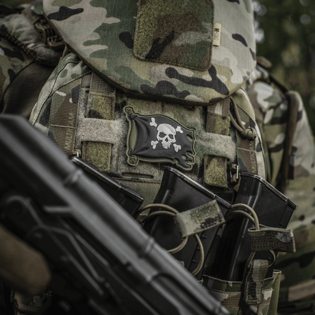M-Tac Jolly Roger PVC on tactical gear with camouflage, symbolizes adventurous spirit and determination.