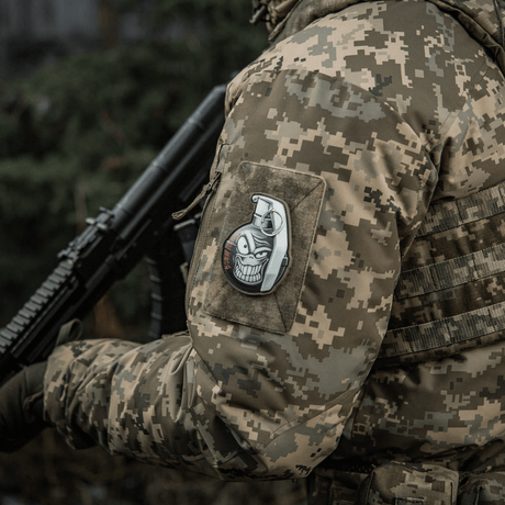 Military enthusiast wearing uniform with M-Tac Patch M67 Grenade 3D PVC on sleeve, showing American M67 grenade with emoji and "Born to Kill" text.