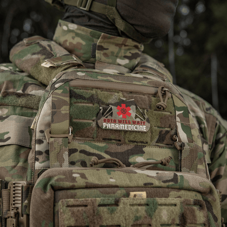 Camouflage uniform with paramedic patch displaying 'Odin Will Wait Paramedicine' emblem.