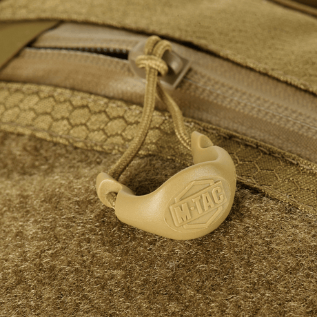 Detail of M-Tac Sling Pistol Bag Elite Hex with Velcro showing zipper and handle with logo, made of durable Cordura material.