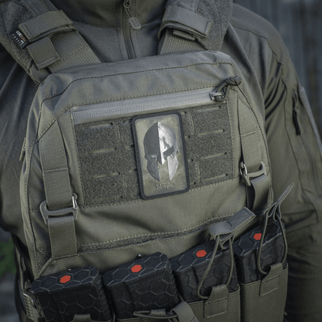 M-Tac Spartan Helmet Patch on a tactical vest, symbolizes courage and strength, made from rugged Cordura 500D, ideal for military gear.