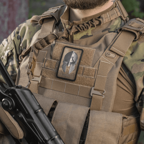 M-Tac Spartan Helmet Patch attached to a tactical vest, symbolizes courage and strength, vintage design in durable Cordura 500D.