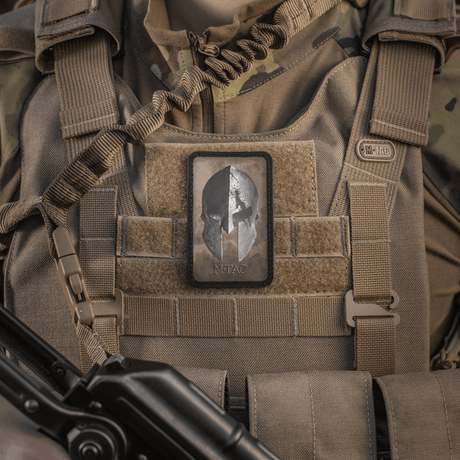 M-Tac Spartan Helmet Patch on a military vest, symbolizes courage and strength, made from durable Cordura 500D with Velcro fastening.