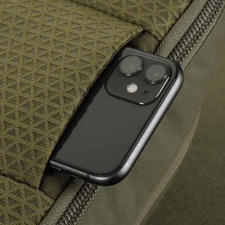 Close-up of M-Tac Sphaera Hardsling Bag Large Elite with Velcro with smartphone in a pocket, showing bag functionality.