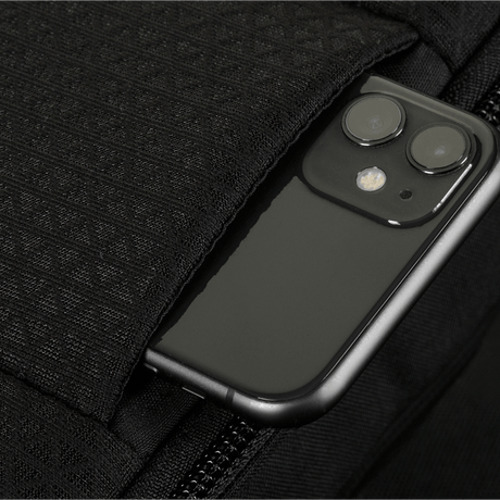 Detail of M-Tac Sphaera Hardsling Bag Large Elite with Velcro showing texture and a pocket with smartphone.