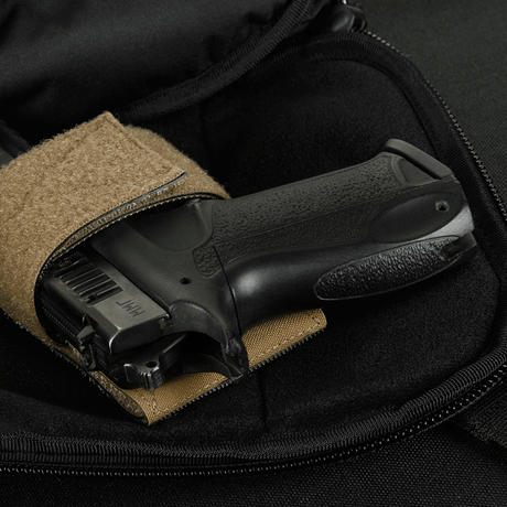 Interior view of M-Tac Sphaera Hex Hardsling Bag Large Elite containing a black pistol.