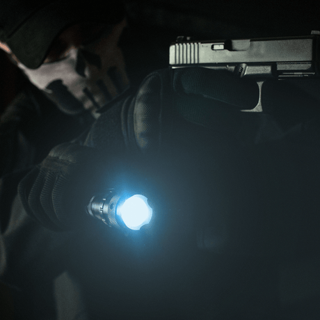 Tactical use of M-Tac flashlight P4 with strong LED beam and pistol in a dark setting.