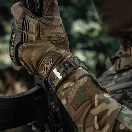 M-Tac Tactical Watch 2037 on an arm in a camouflage jacket, ideal for outdoor and tactical use.
