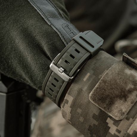 M-Tac Tactical Watch with Compass 2233 on a soldier's wrist, rugged watch for tactical use and outdoor activities.