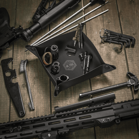 M‑Tac Maintenance Tray 24x24 cm used for firearm cleaning and maintenance at a training range.