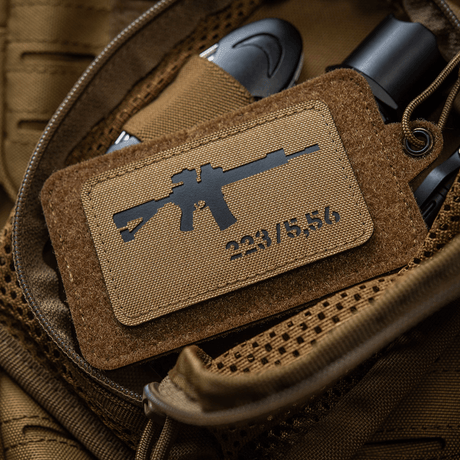 M-Tac AR-15 223/5,56 Laser Cut Patch in Cordura 500D with Velcro back, placed on tactical bag, durable for outdoor use.