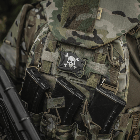 M-Tac Jolly Roger PVC patch attached to a tactical camouflage backpack, symbolizes adventurous spirit and determination.