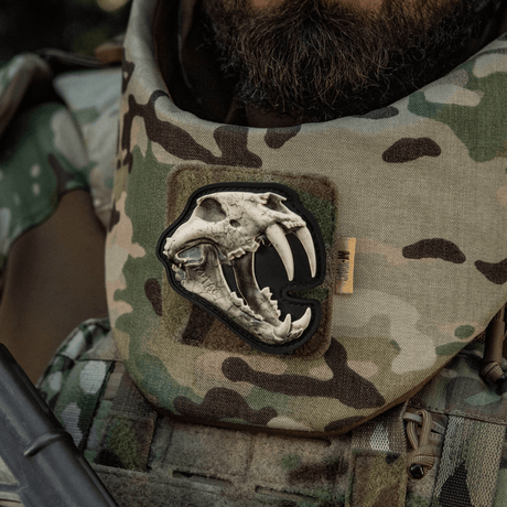 M‑Tac Patch Old Tiger, 3D tiger skull PVC patch on a camouflage jacket, symbol of courage and experience.