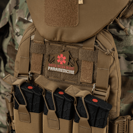 M-Tac Patch Viking Evac on tactical vest, camouflage background, includes paramedic emblem.