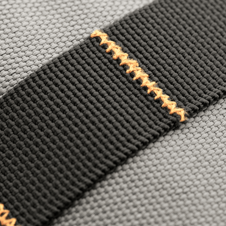 M-Tac Urban Line City Patrol bag material close-up of black shoulder strap with orange stitching, 600D polyester, water-repellent.