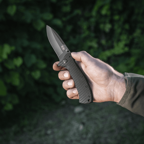 M-Tac Outdoor & Military folding knife - Type 7 with chrome stainless steel blade held in hand, made for tactical purposes.