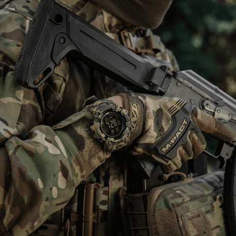 M-Tac Tactical Watch 2037 worn by person in camouflage with tactical gear and firearm.