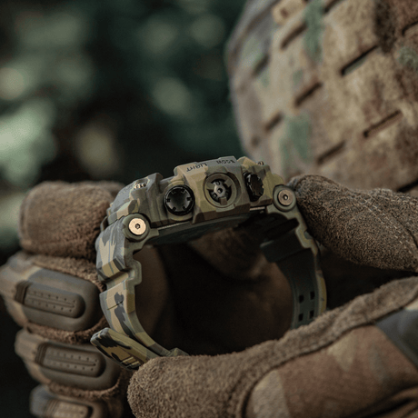M-Tac Tactical Watch 2037 held by a gloved person in an outdoor setting, rugged design suitable for outdoor, tactical and everyday use.