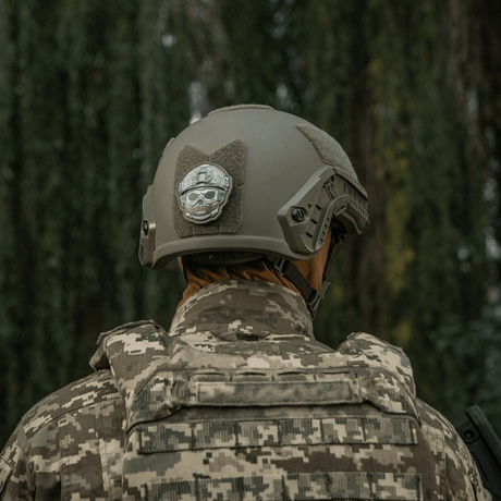 M-Tac Patch Emoji #4 with 3D effect mounted on a tactical helmet with a camouflage background. Fun morale patch for gear.