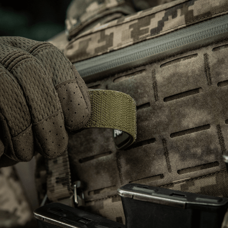 M-Tac Patch Autosave PVC on a tactical backpack, PVC material, Velcro backing, 3D effect, shown in use in the field.